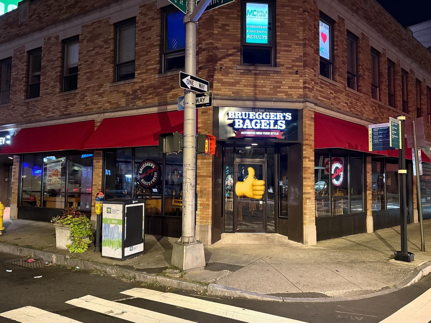 Illuminated storefront sign serviced at night