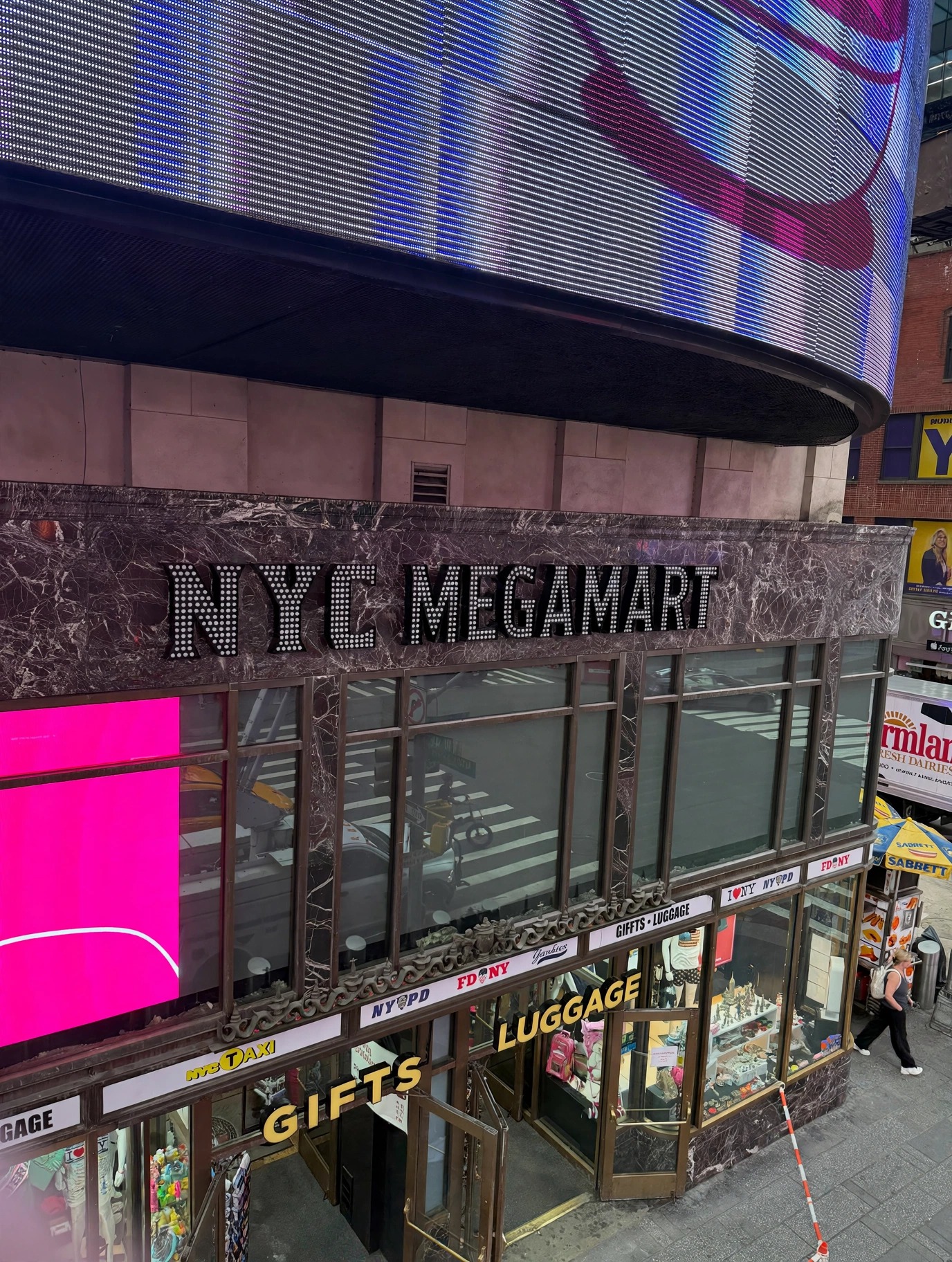 Bright illuminated storefront signage for a supermarket at night